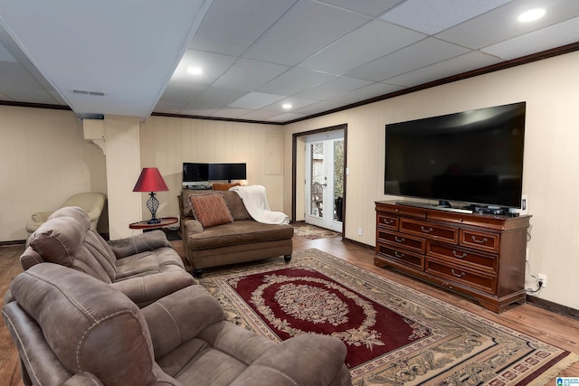 living room with hardwood / wood-style floors, crown molding, and french doors