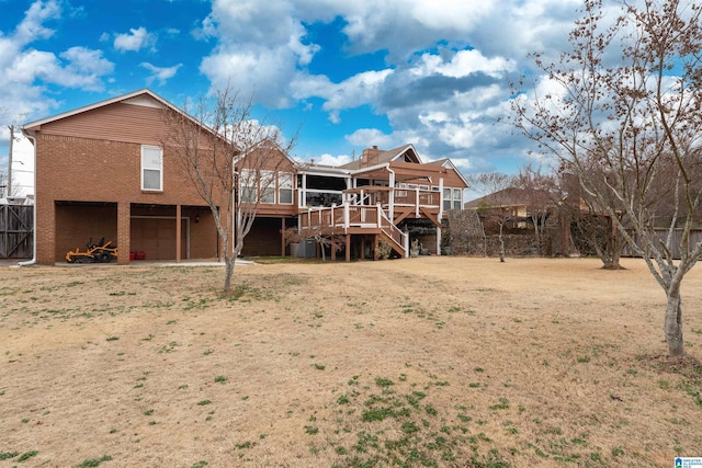 back of house with a wooden deck and a garage