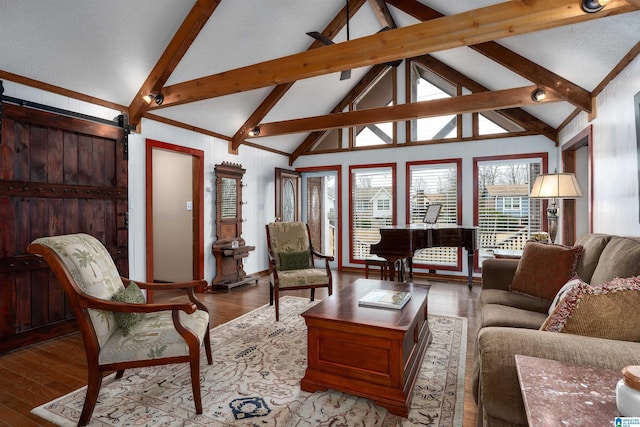 living room with beam ceiling, a barn door, high vaulted ceiling, and light hardwood / wood-style floors