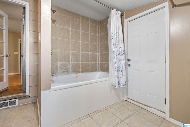 full bath featuring tile patterned flooring, shower / bath combo, and visible vents