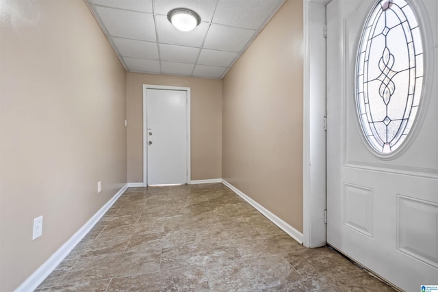 entrance foyer with a drop ceiling and baseboards