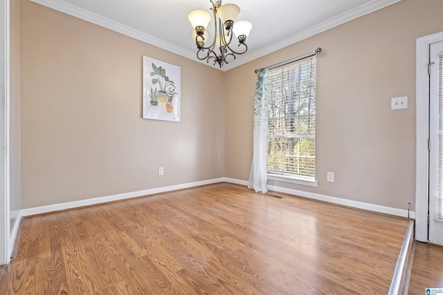 empty room featuring visible vents, baseboards, ornamental molding, light wood finished floors, and an inviting chandelier