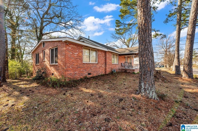 view of property exterior featuring brick siding and crawl space