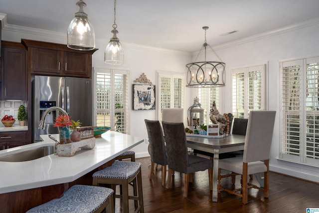 dining area with ornamental molding, a healthy amount of sunlight, dark hardwood / wood-style floors, and sink