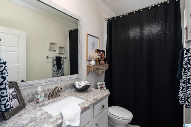 bathroom with ornamental molding, vanity, and toilet