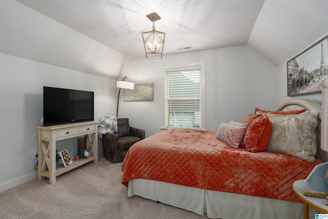 carpeted bedroom featuring vaulted ceiling and an inviting chandelier