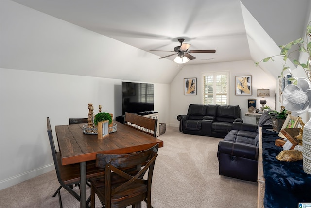 carpeted dining room featuring vaulted ceiling and ceiling fan