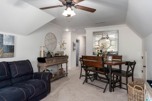 carpeted dining room featuring ceiling fan, ornamental molding, and vaulted ceiling