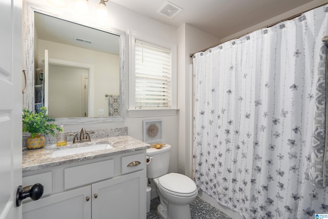 bathroom featuring walk in shower, vanity, and toilet