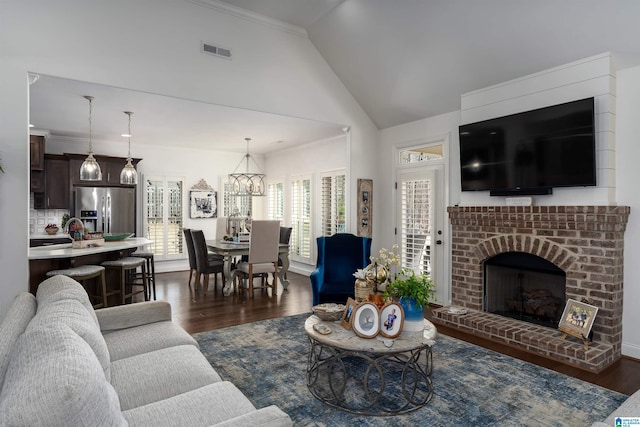 living room with lofted ceiling, ornamental molding, and dark hardwood / wood-style floors