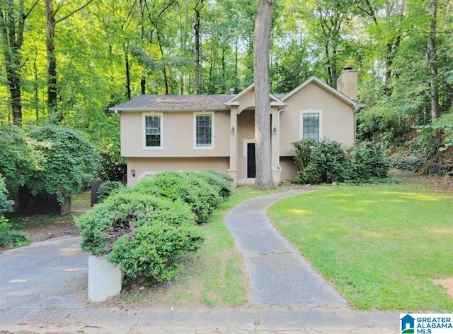 raised ranch with a front lawn