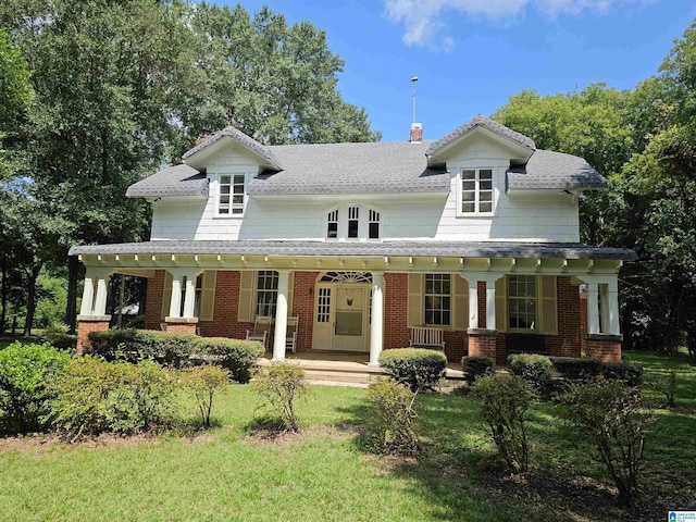 view of front facade with a front yard and a porch