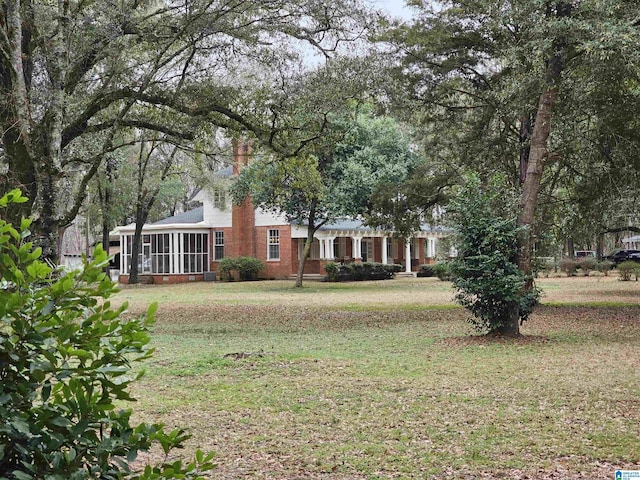 view of yard featuring a sunroom