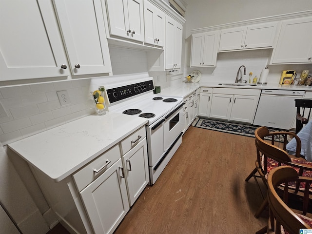 kitchen with white cabinetry, sink, white appliances, and dark wood-type flooring