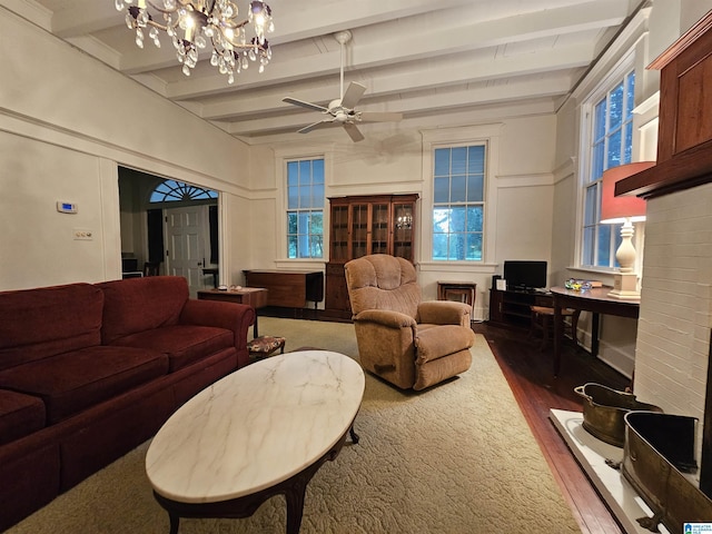 living room featuring dark hardwood / wood-style flooring, ceiling fan, and beamed ceiling