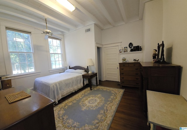 bedroom featuring beamed ceiling and dark hardwood / wood-style floors