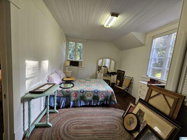 bedroom with lofted ceiling and dark hardwood / wood-style floors