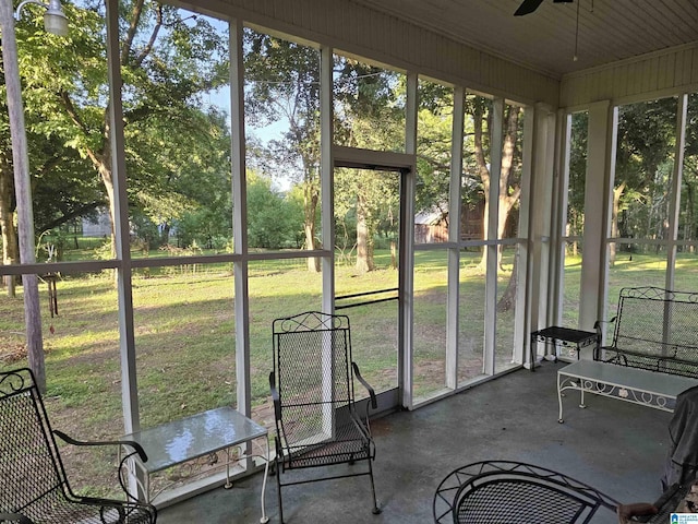 unfurnished sunroom featuring ceiling fan