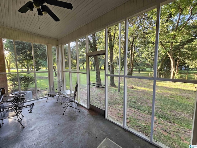 unfurnished sunroom with ceiling fan