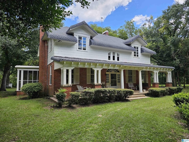 view of front of house with a porch, a front lawn, and a sunroom