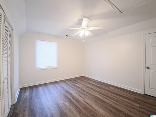 unfurnished bedroom with lofted ceiling, dark hardwood / wood-style floors, and ceiling fan