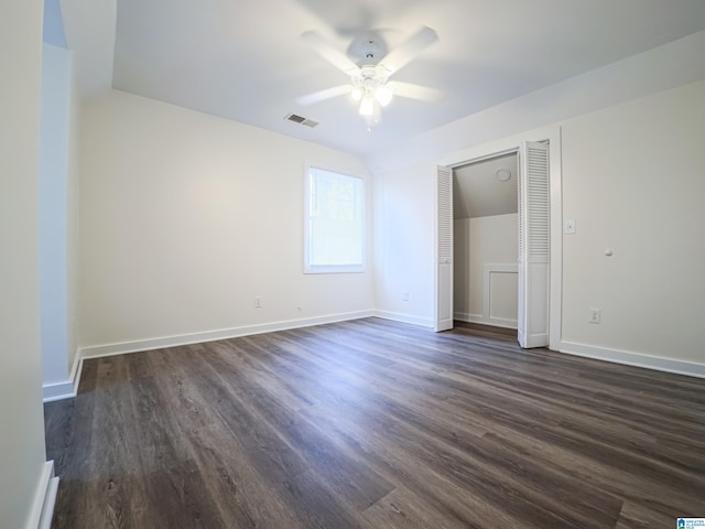 unfurnished bedroom with dark hardwood / wood-style floors, ceiling fan, and a closet