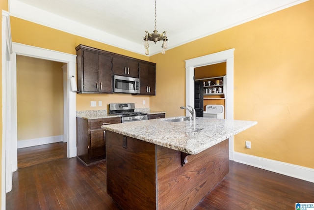 kitchen featuring dark hardwood / wood-style floors, an island with sink, sink, dark brown cabinetry, and stainless steel appliances