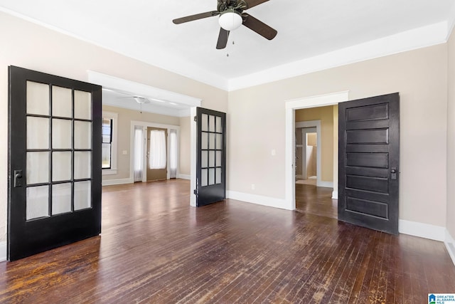 empty room featuring dark wood-type flooring and ceiling fan