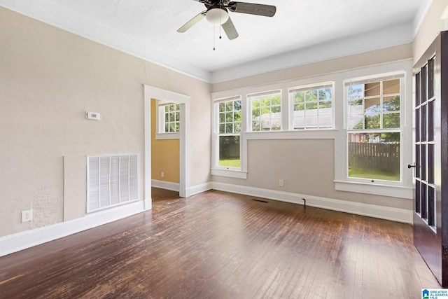 unfurnished room with ceiling fan, ornamental molding, and dark hardwood / wood-style flooring