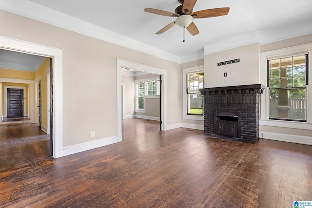 unfurnished living room with ceiling fan, ornamental molding, dark hardwood / wood-style floors, and a fireplace