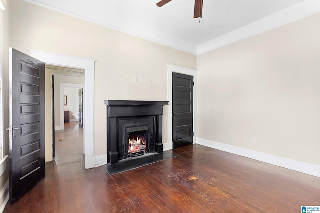 unfurnished living room featuring crown molding, ceiling fan, and dark hardwood / wood-style flooring