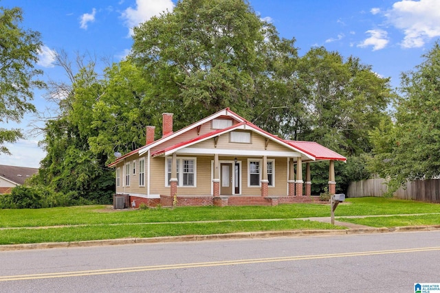 view of front of property featuring covered porch, a front yard, and central air condition unit