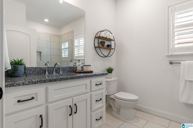 bathroom featuring vanity, toilet, and a shower with door