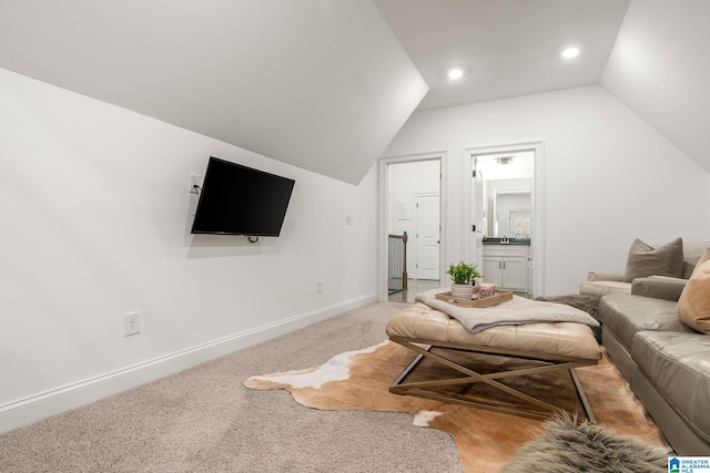 carpeted living room featuring vaulted ceiling