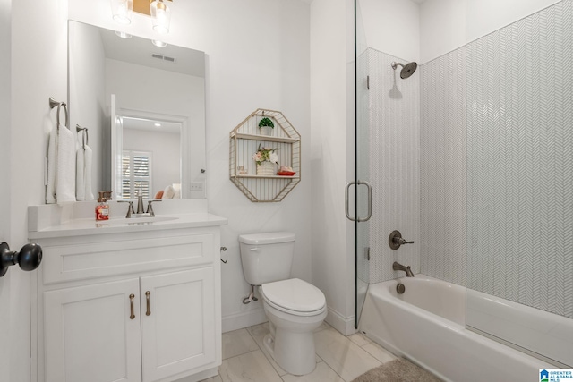 full bathroom with enclosed tub / shower combo, vanity, and toilet