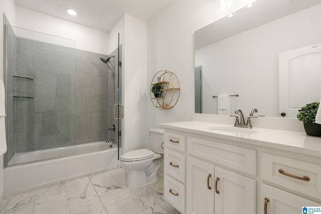 full bathroom featuring vanity, combined bath / shower with glass door, and toilet