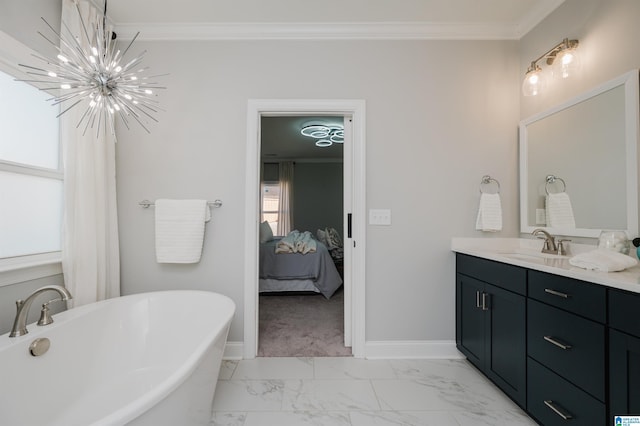 bathroom featuring crown molding, vanity, a chandelier, and a bathtub