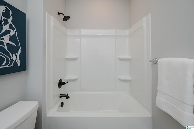 bathroom featuring shower / bathtub combination and toilet