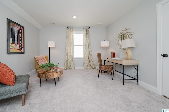 living area featuring light colored carpet