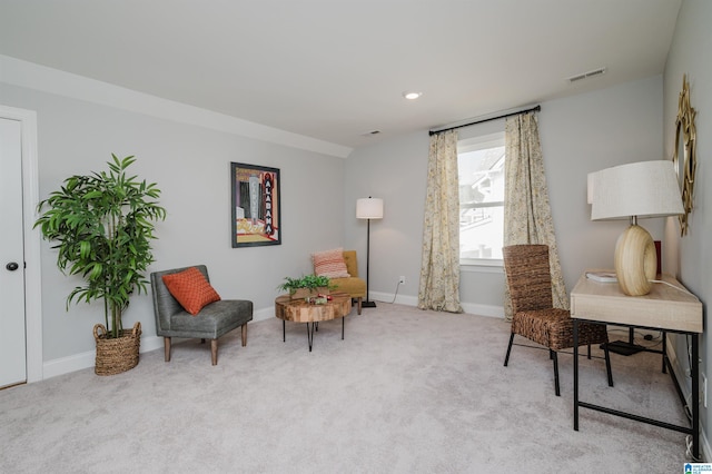 sitting room featuring light colored carpet