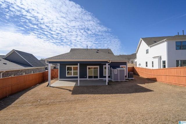 rear view of house with central AC and a patio area