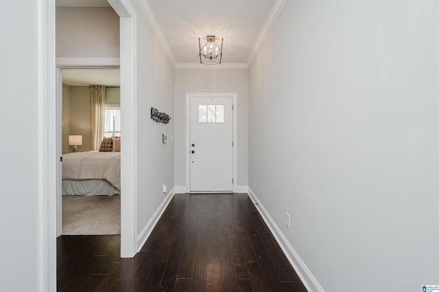 doorway with crown molding, dark hardwood / wood-style floors, and a chandelier