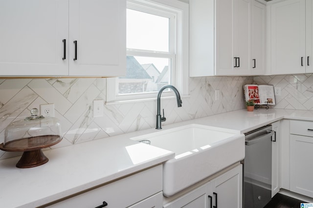 kitchen with tasteful backsplash, dishwasher, sink, and white cabinets