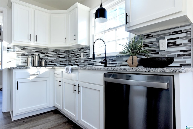 kitchen featuring white cabinetry, hanging light fixtures, decorative backsplash, and dishwasher