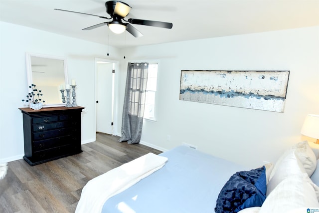 bedroom with hardwood / wood-style floors and ceiling fan