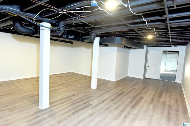 basement featuring hardwood / wood-style flooring