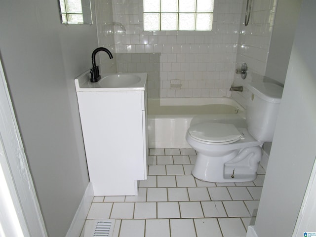 full bathroom featuring tiled shower / bath, vanity, toilet, and tile patterned flooring