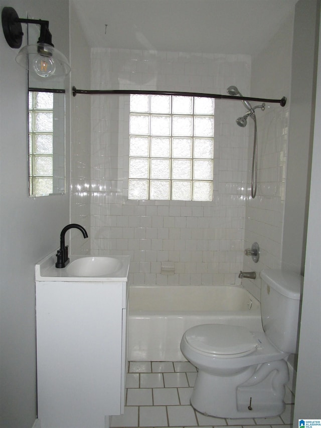 full bathroom with vanity, tiled shower / bath combo, and toilet