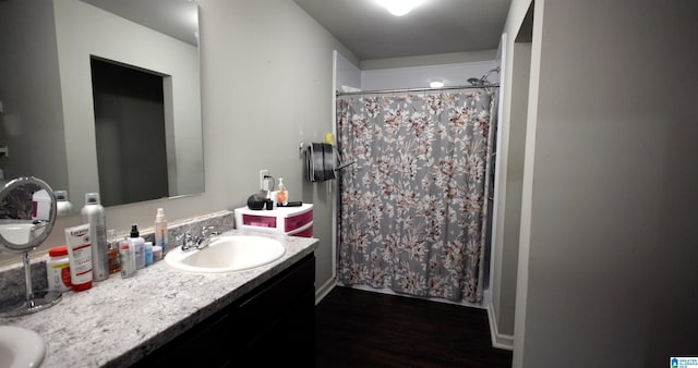 bathroom with vanity, wood-type flooring, and walk in shower