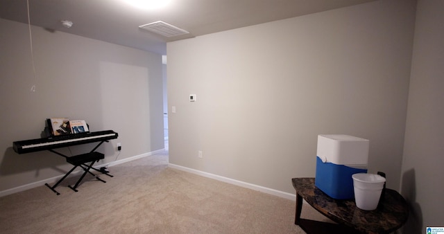 miscellaneous room featuring light colored carpet